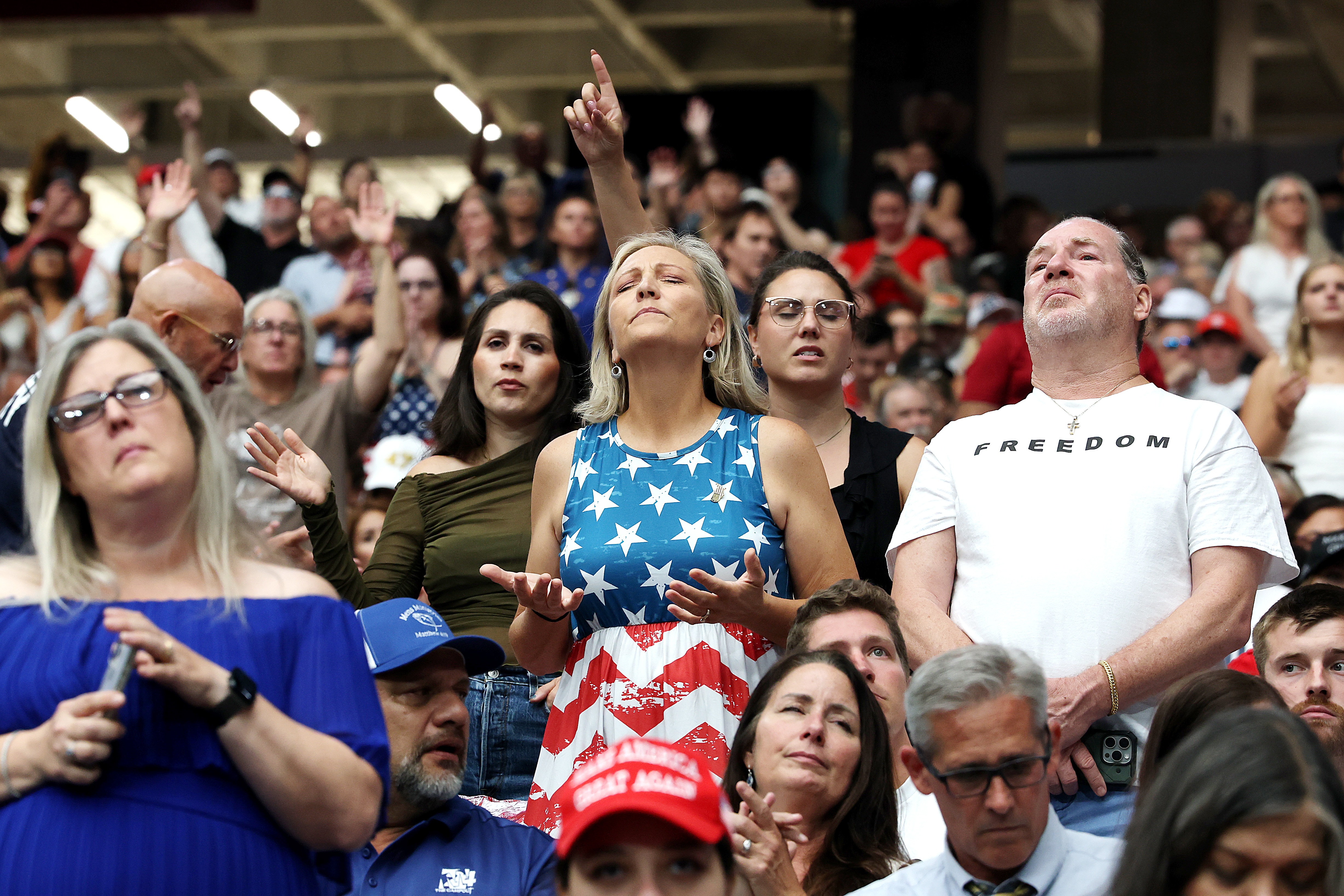 Attendees await the start of the memorial service for political activist Charlie Kirk at State Farm Stadium on Sunday in Glendale, Ariz.